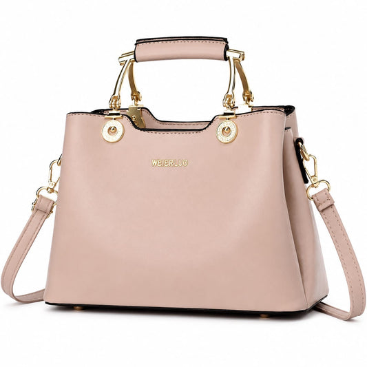 Blush pink vegan leather structured satchel handbag with gold hardware and top handle, featuring a crossbody strap for women.